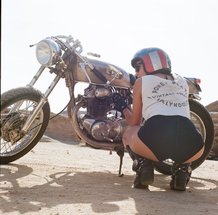 A playful frame from Girls on a motorcycle — online in Mumbai